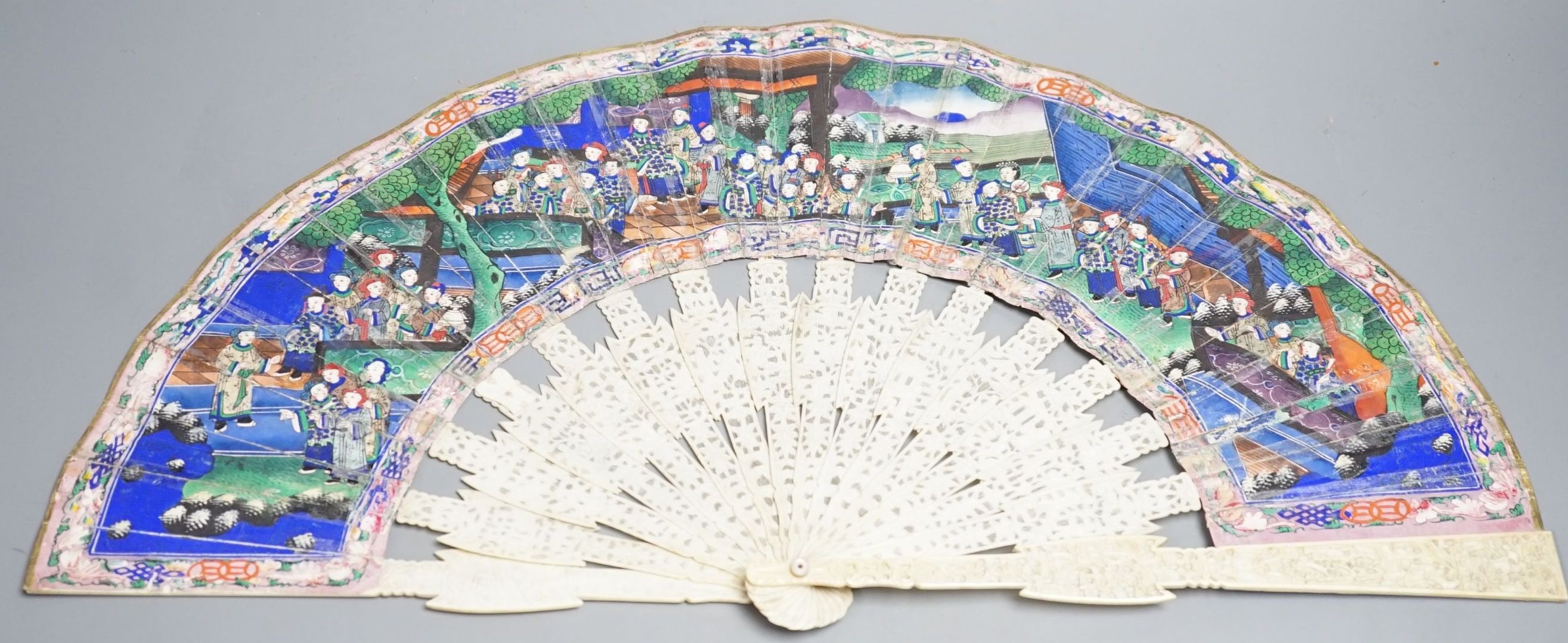 A 19th century Chinese export pierced ivory and painted paper leaf fan, in box. Fan 28cm long